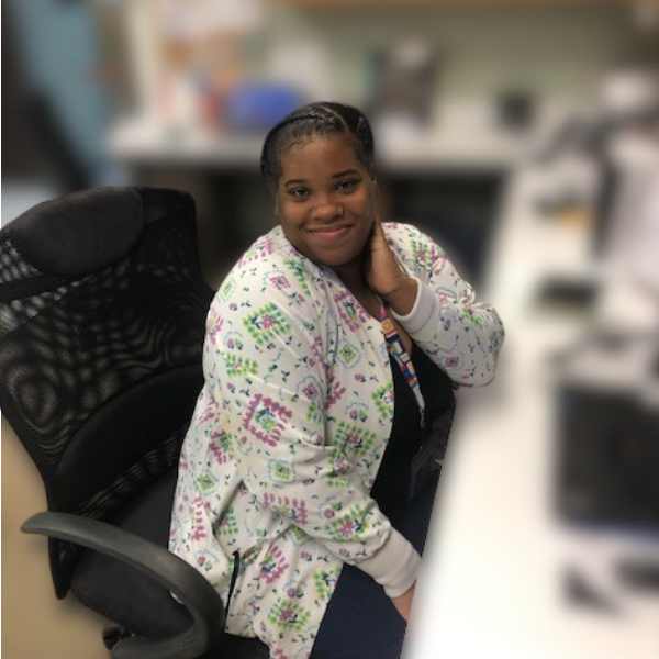 Johnna Hester smiling at desk