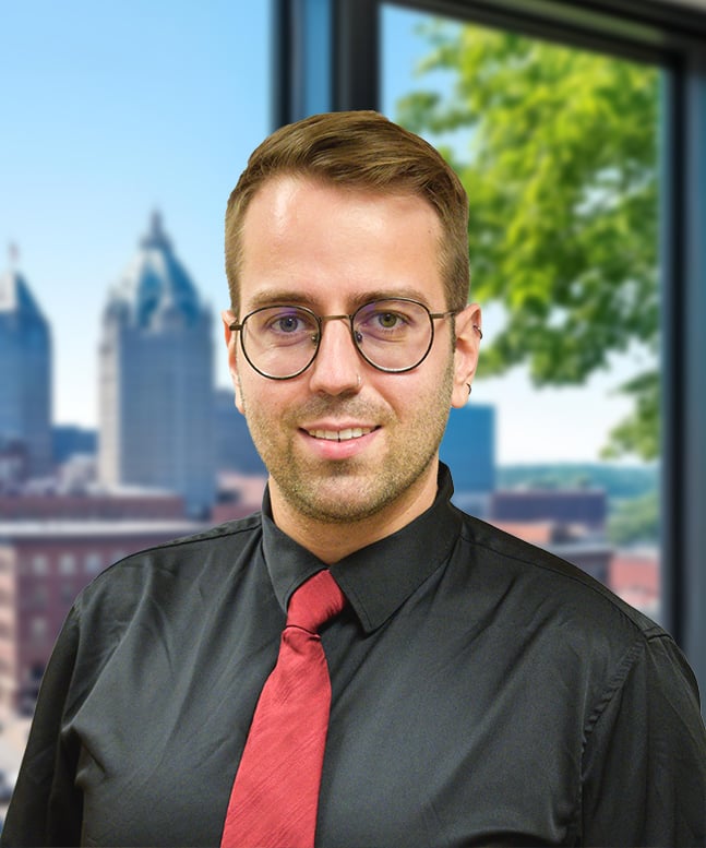 Photo for Dr. Dammann, white, short blonde hair, grey shirt, and red tie