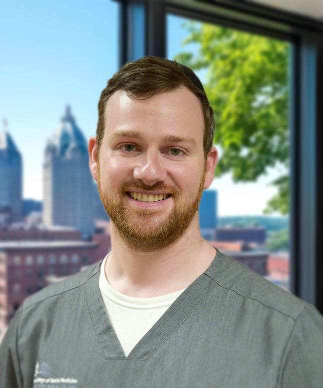 Alan Feldstein, dentist, short brown hair, short reddish-brown beard and moustache, and a gentle smile.