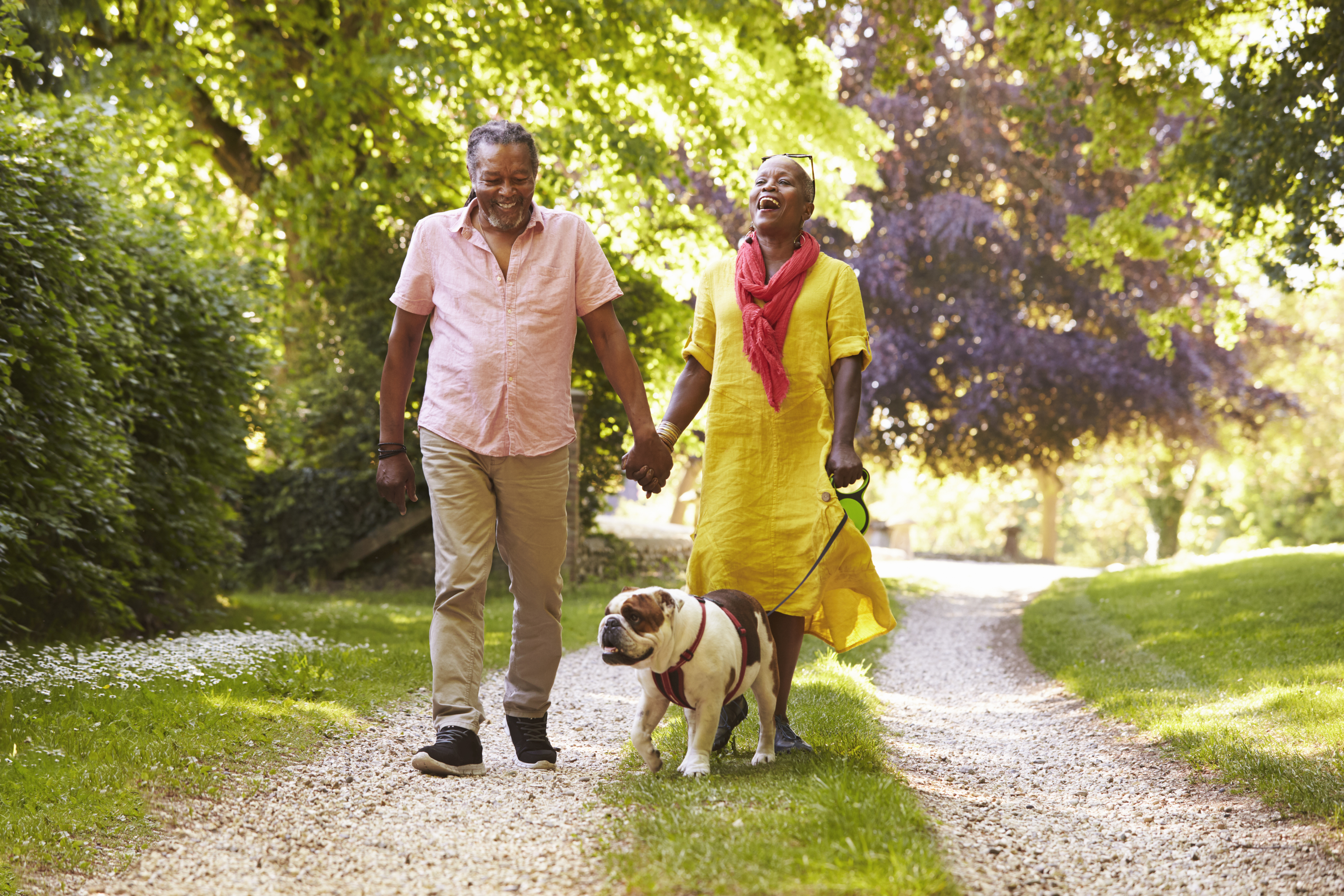 Couple walking their bulldog.