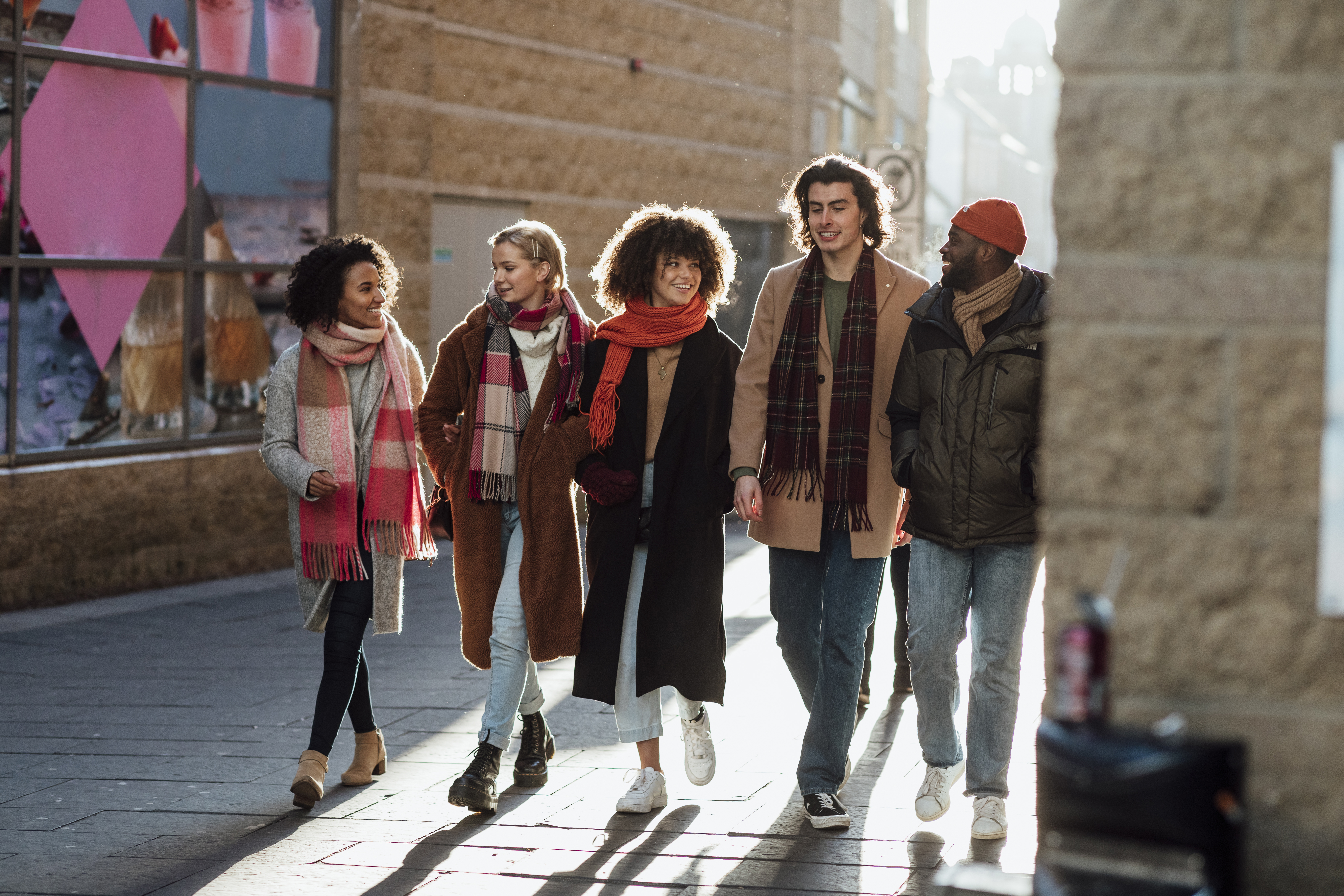 Group of friends walking in city.
