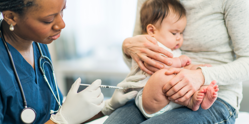 Baby gets vaccinated by doctor.