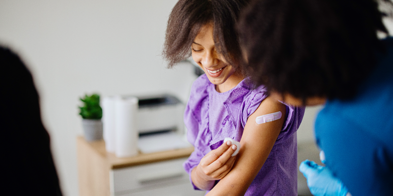 Teen happy after vaccine is finished.