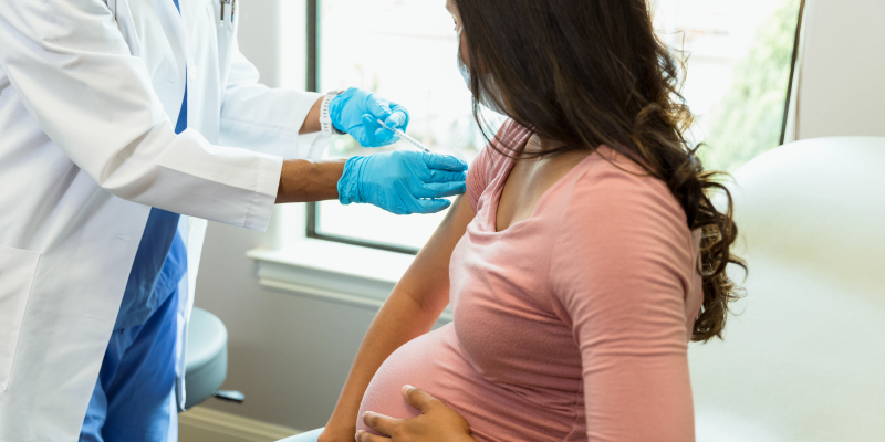 Pregnant person gets vaccinated.