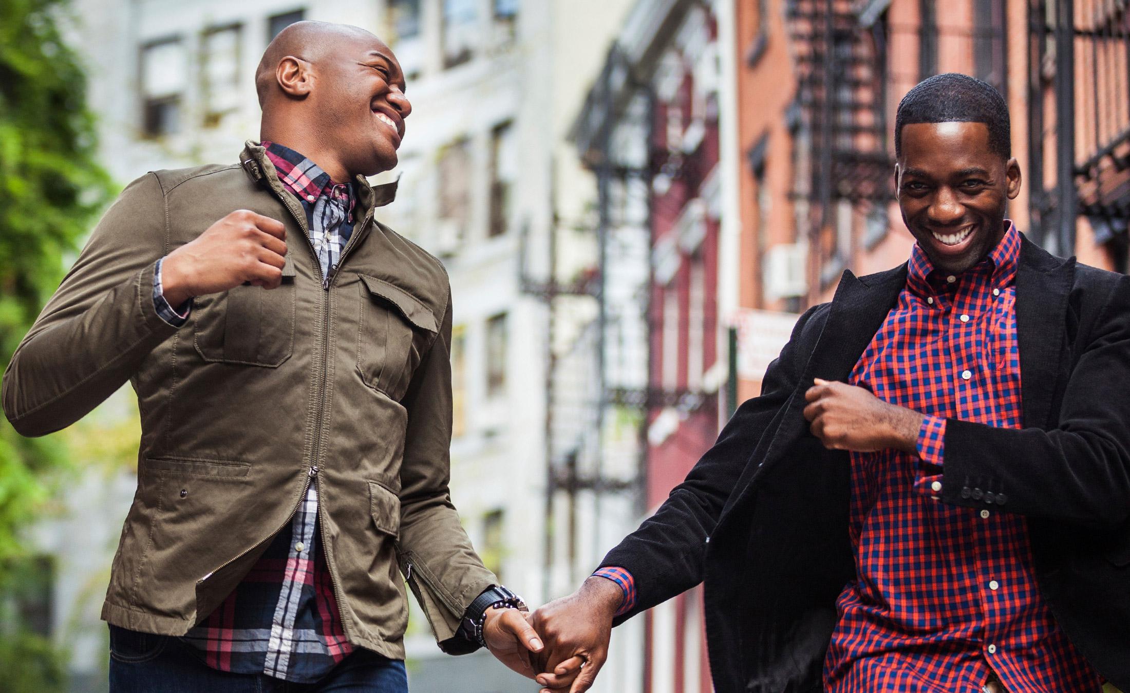 Happy gay couple holding hands