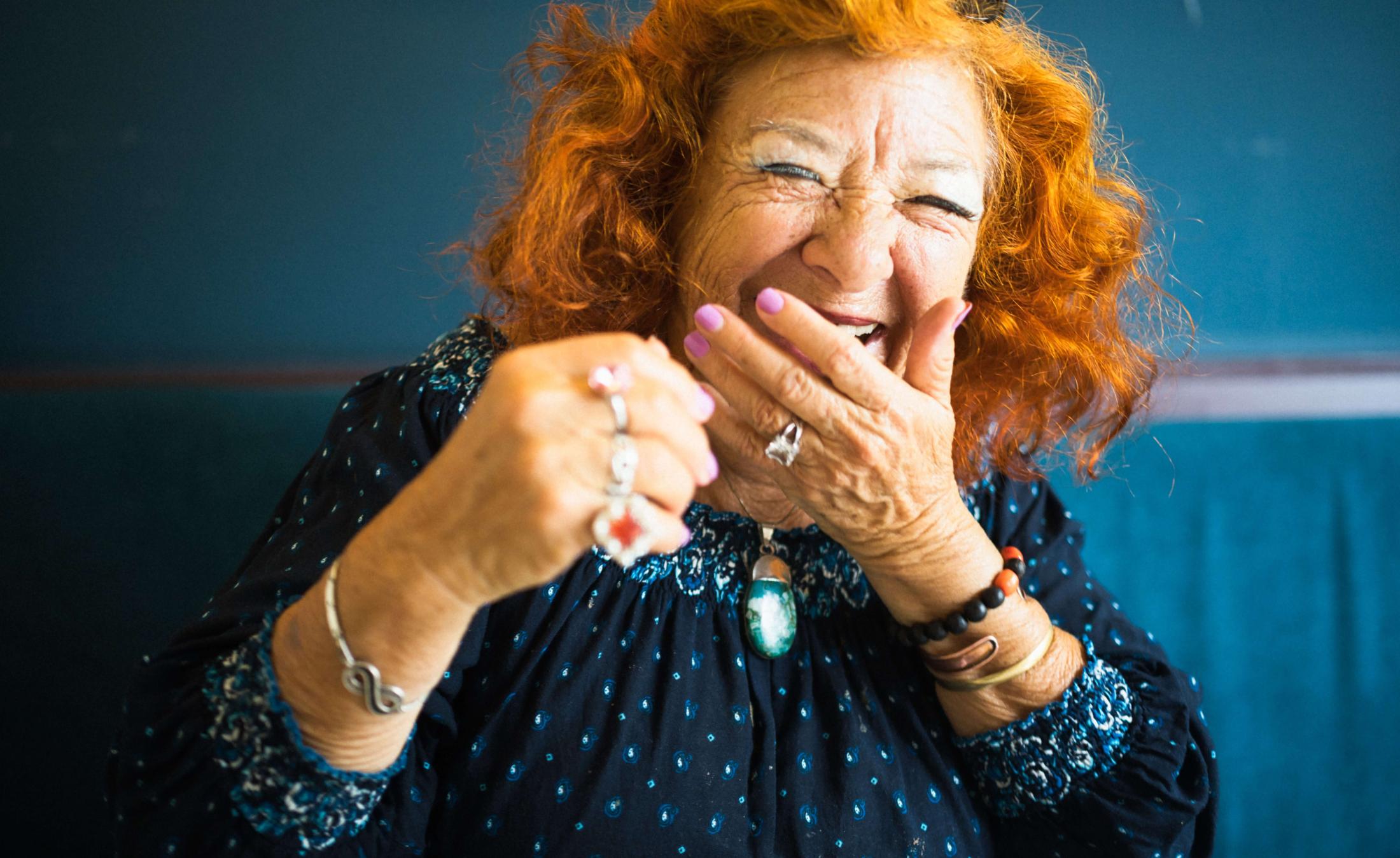 Laughing elderly woman with bright red hair