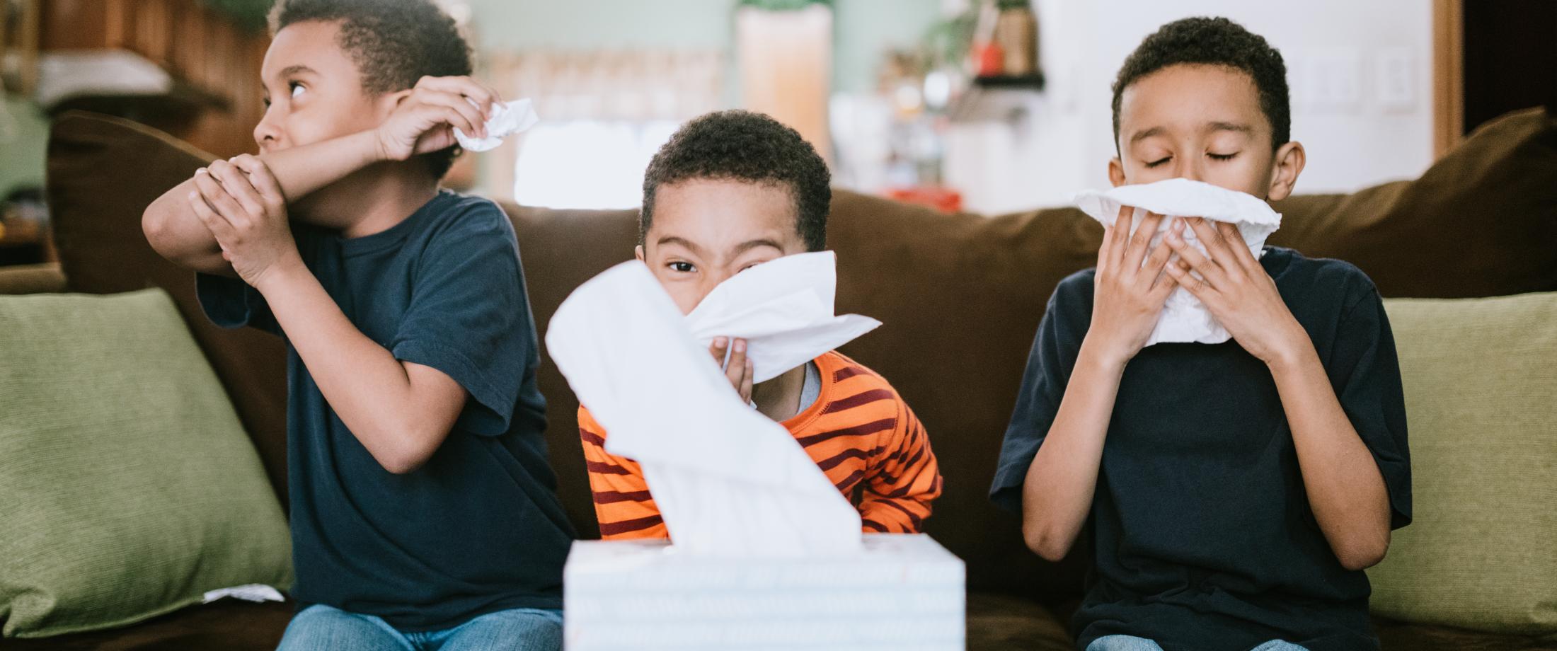 Three kids coughing, sneezing, and blowing their nose.