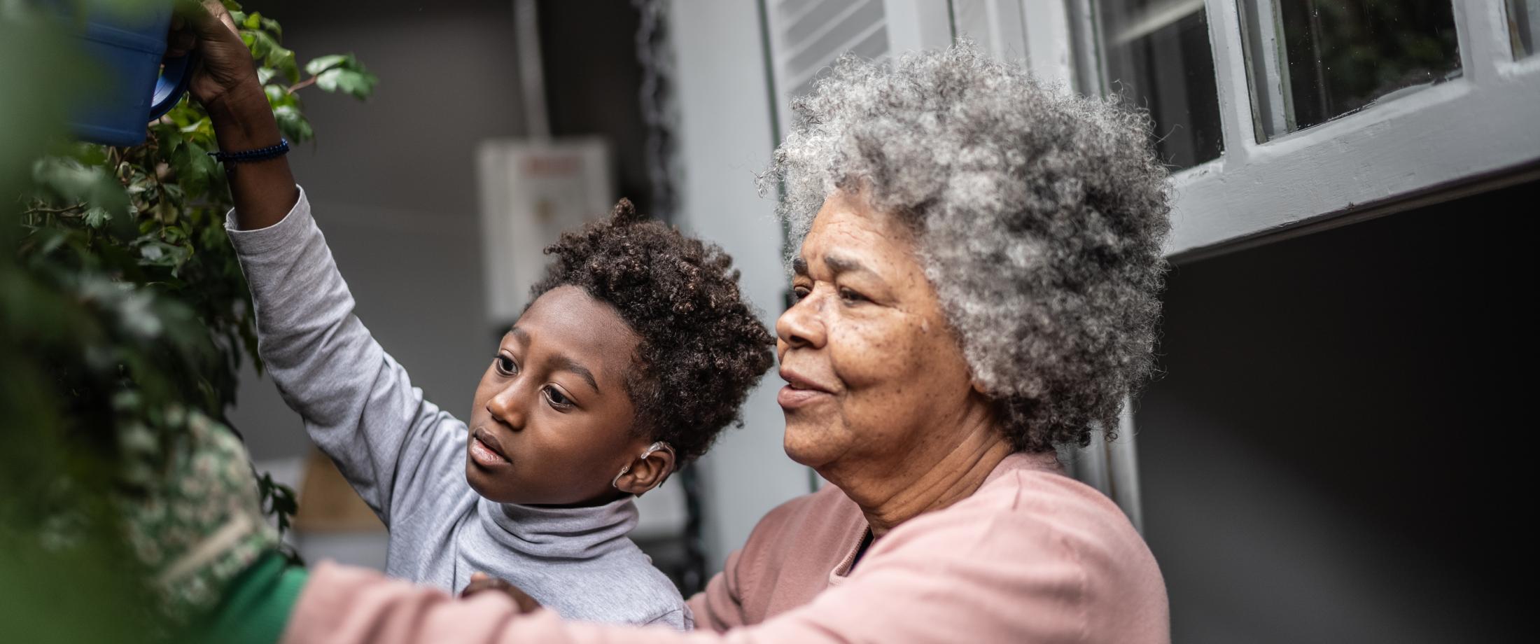 Grandparent and grandchild gardening.