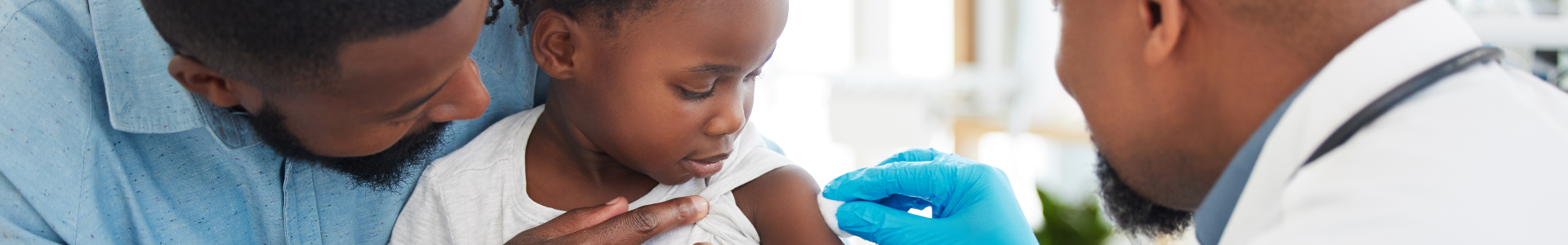 Toddler getting ready for a vaccine from doctor.