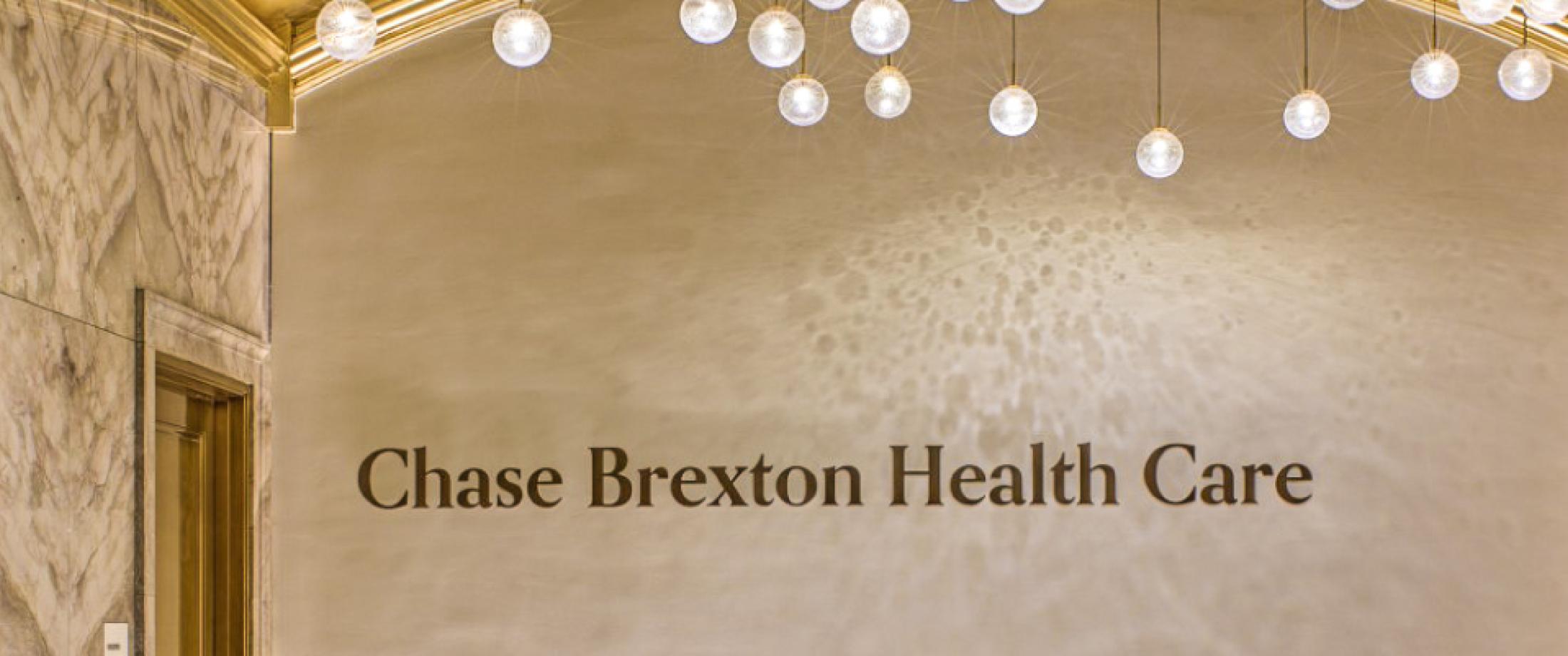 A creamy office building wall with "Chase Brexton Health Care" signage