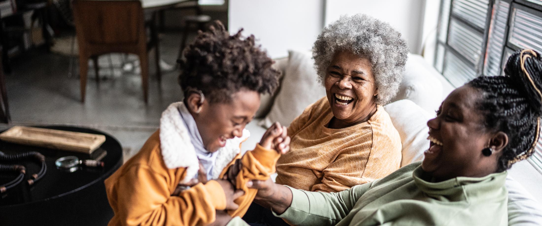 Three generations laughing together.