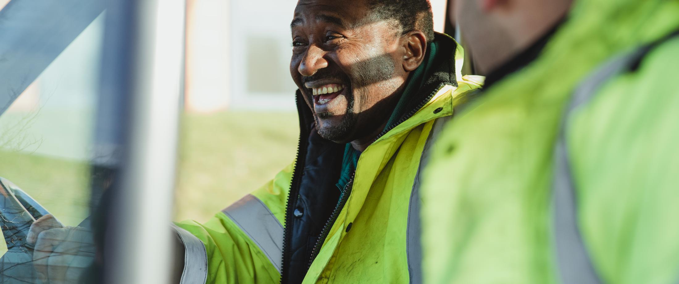 Two workers laughing.