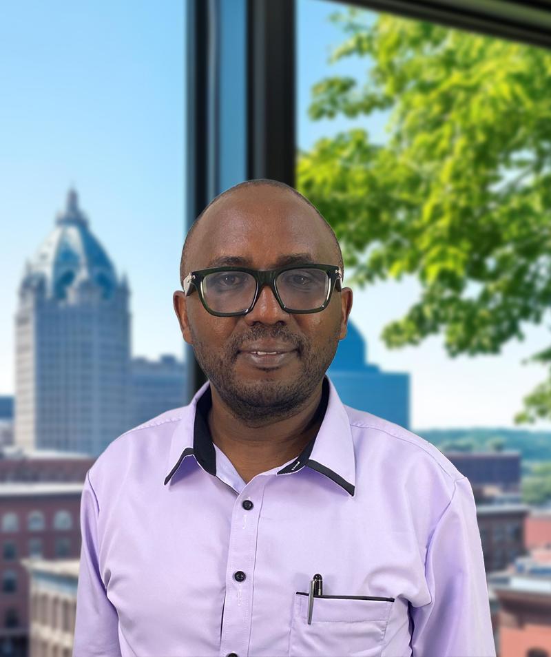A headshot of John Mburu