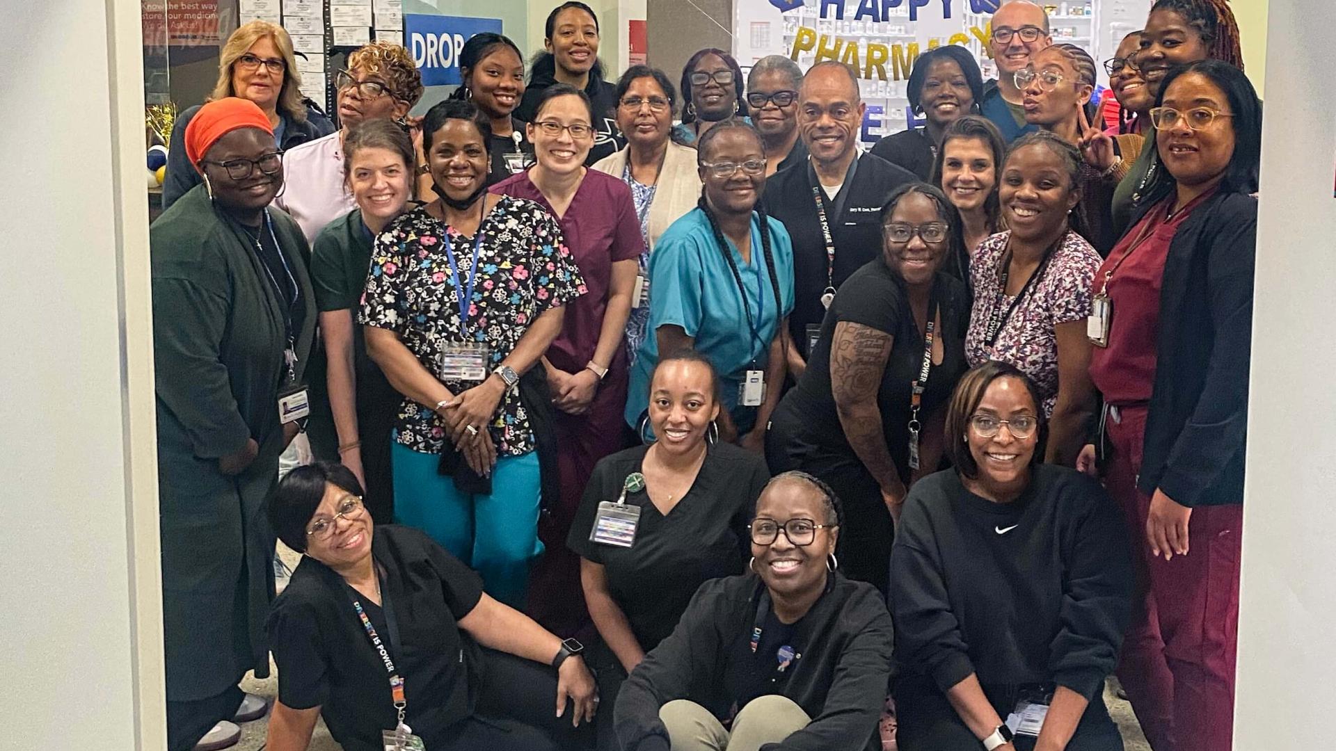 A group of people posing together in the Pharmacy department