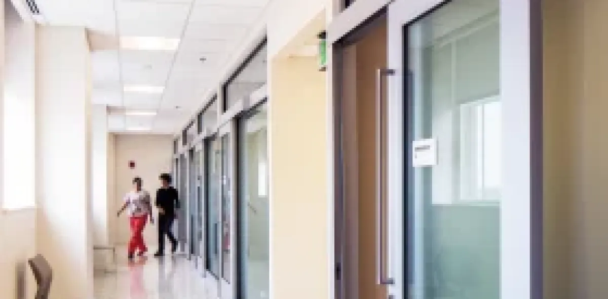 Patients walking in a long hallway
