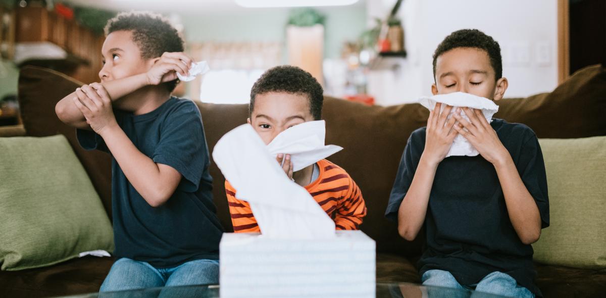 Three kids coughing, sneezing, and blowing their nose.