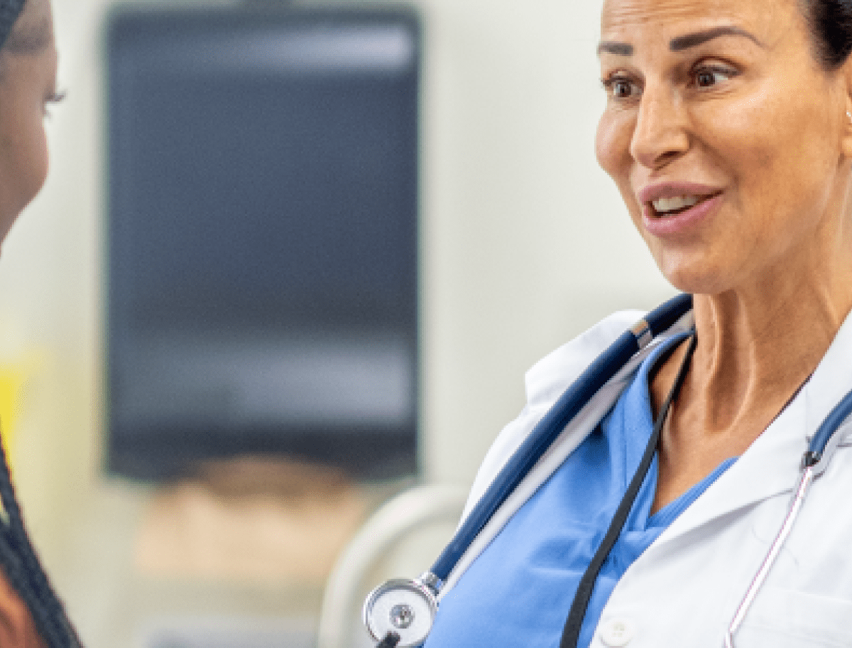 Smiling doctor talking to a patient