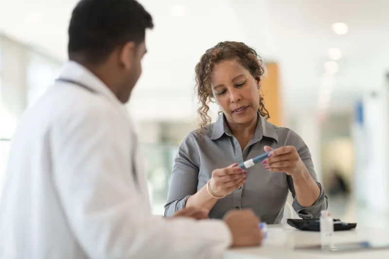 Doctor looking at medicine with another doctor in a white coat