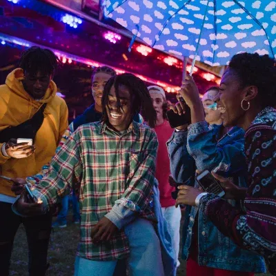 Teens dancing together in a colorful, night club style location