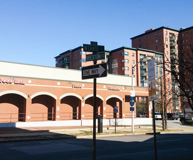 Street corner with intersecting W. Chase Street and Brexton Street signs