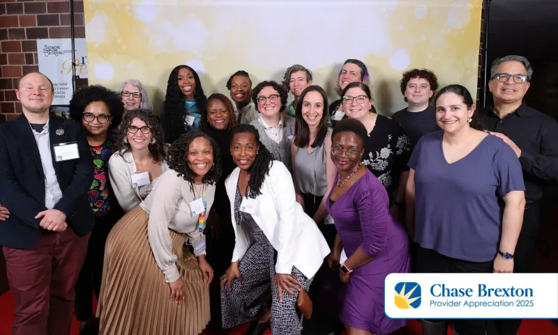 A group of people posing together in front of a backdrop during Providers Appreciation Day