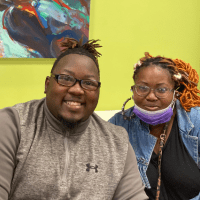 Andr'a and friend sitting in a colorful room