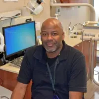 Tony Robinson sitting at a computer